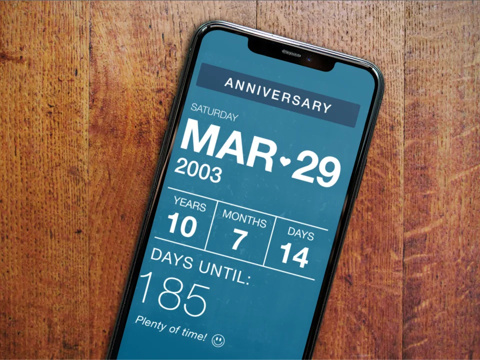 Hubby Helper mobile app displayed on a phone against a wood background